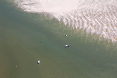 Boats and people dow below in the sand