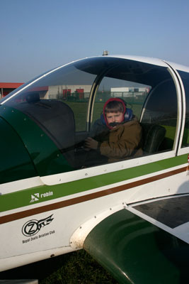 Son posing at aircraft